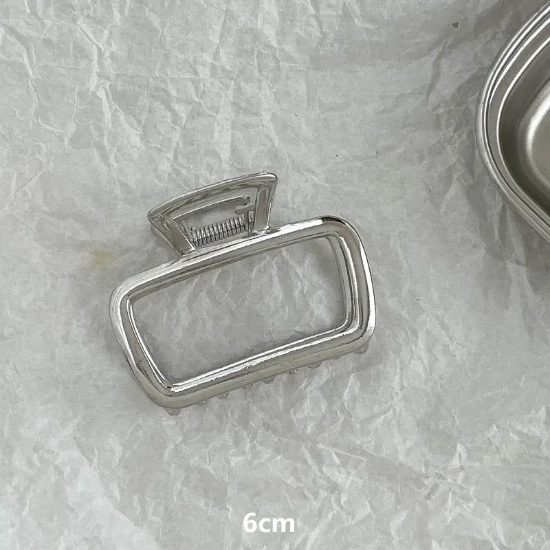 Assortment of silver metal hair barrettes and claw clips in various Korean-style designs on a white background.