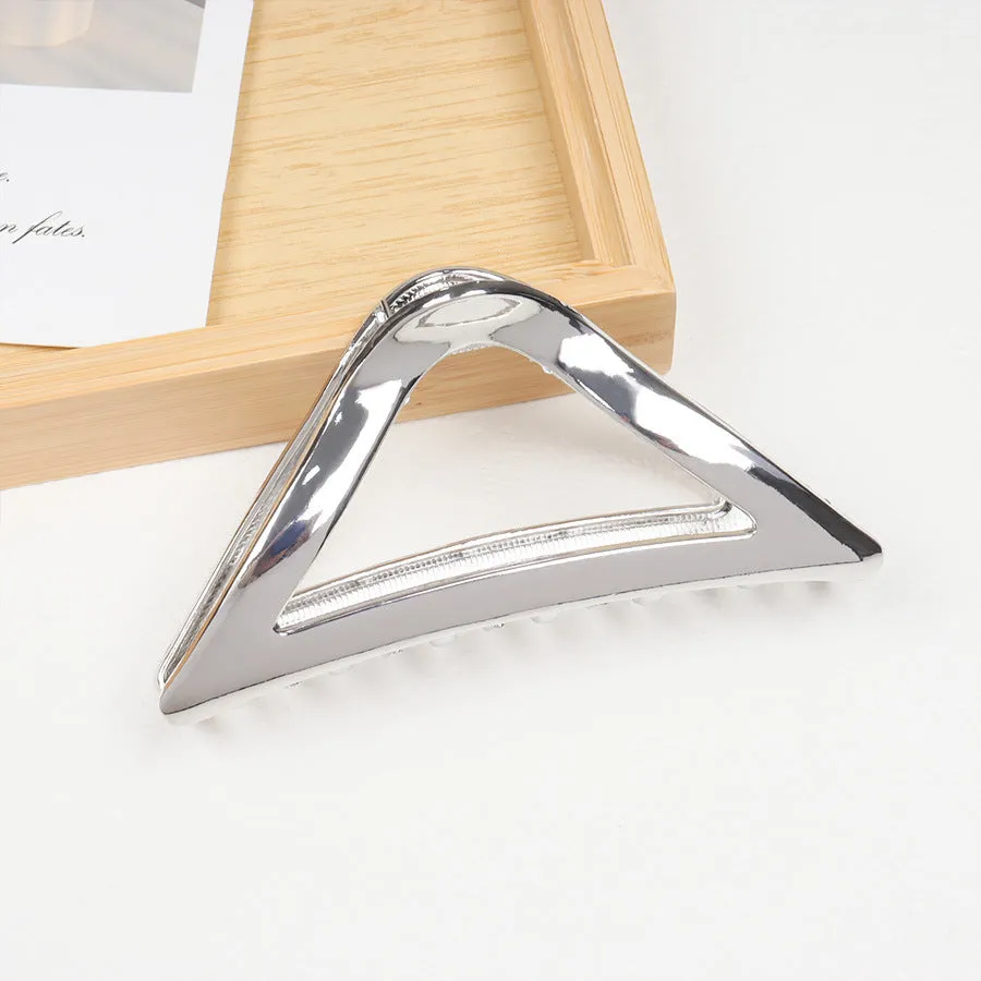 Assortment of silver metal hair barrettes and claw clips in various Korean-style designs on a white background.