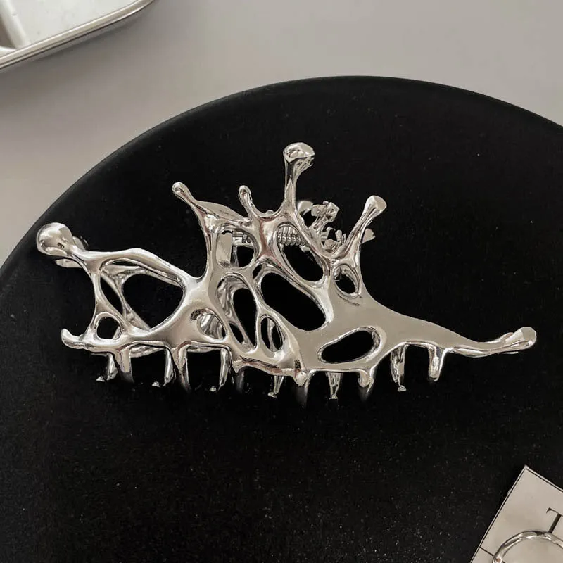 Assortment of silver metal hair barrettes and claw clips in various Korean-style designs on a white background.