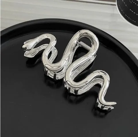Assortment of silver metal hair barrettes and claw clips in various Korean-style designs on a white background.