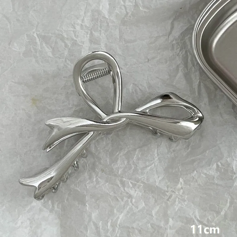 Assortment of silver metal hair barrettes and claw clips in various Korean-style designs on a white background.