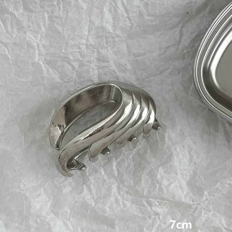 Assortment of silver metal hair barrettes and claw clips in various Korean-style designs on a white background.