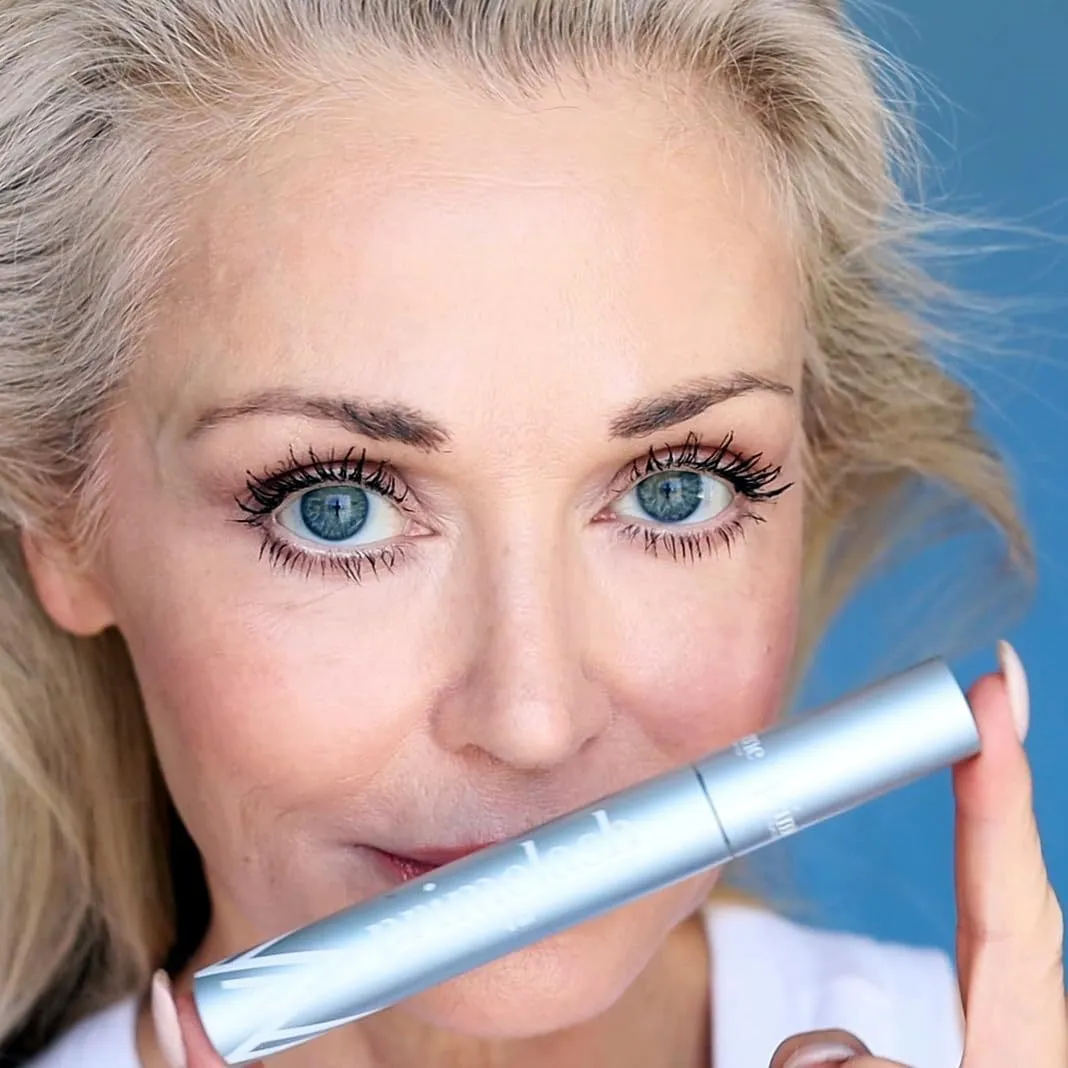 Compact black eyelash and eyebrow grooming stick beauty tool.