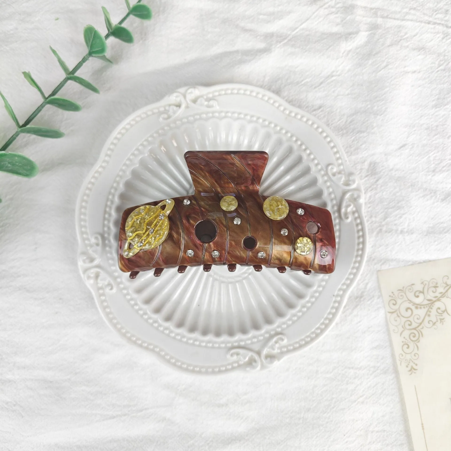 Oversized women's barrette with star moon starry sky design in cellulose acetate sheet material