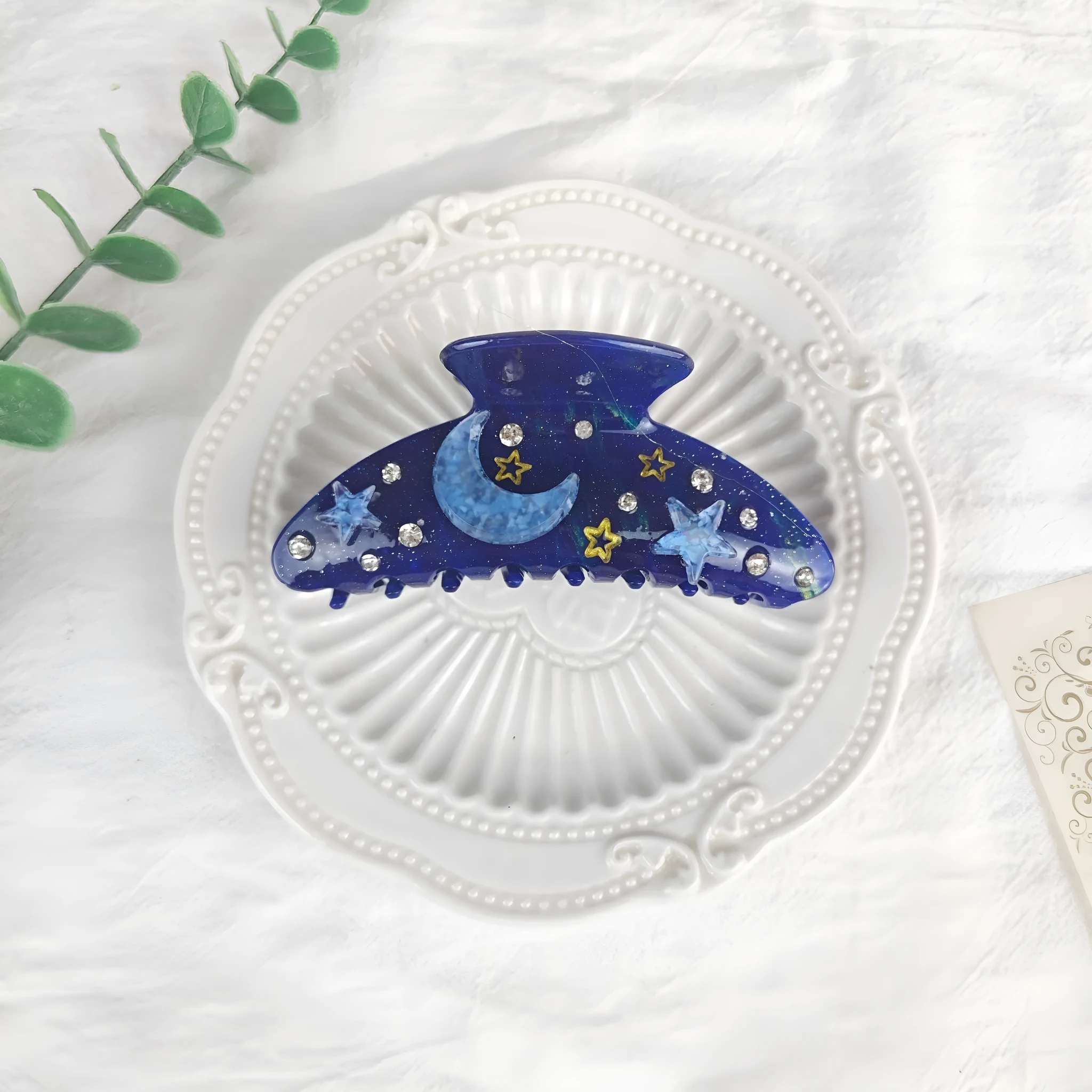 Oversized women's barrette with star moon starry sky design in cellulose acetate sheet material