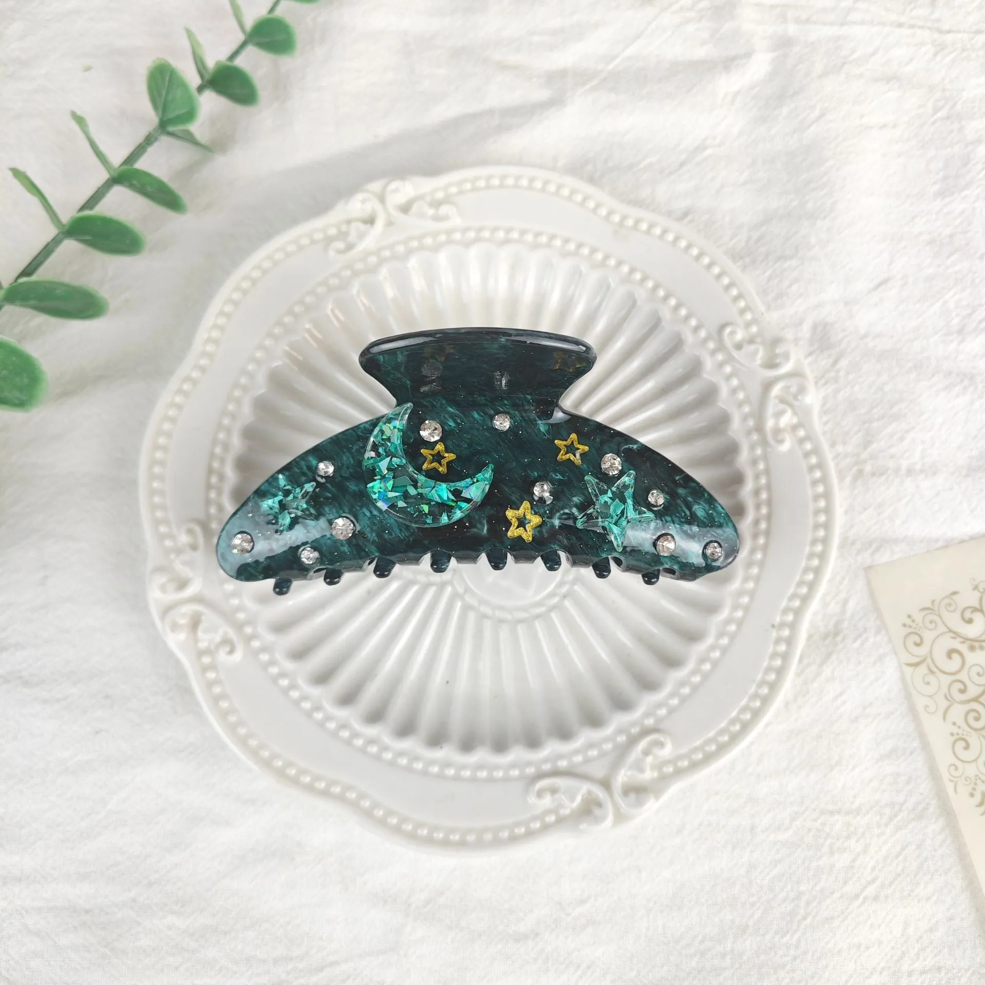 Oversized women's barrette with star moon starry sky design in cellulose acetate sheet material