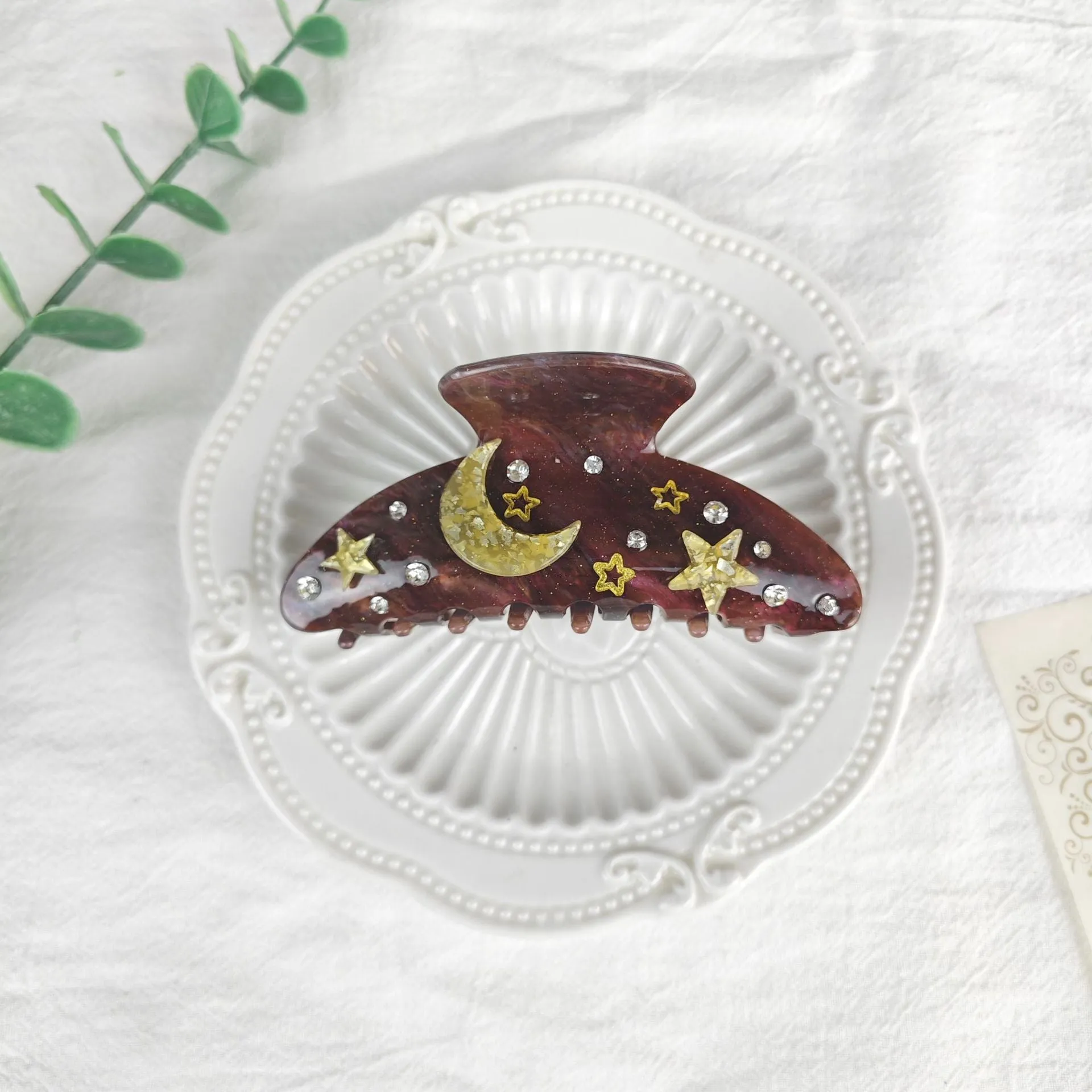 Oversized women's barrette with star moon starry sky design in cellulose acetate sheet material