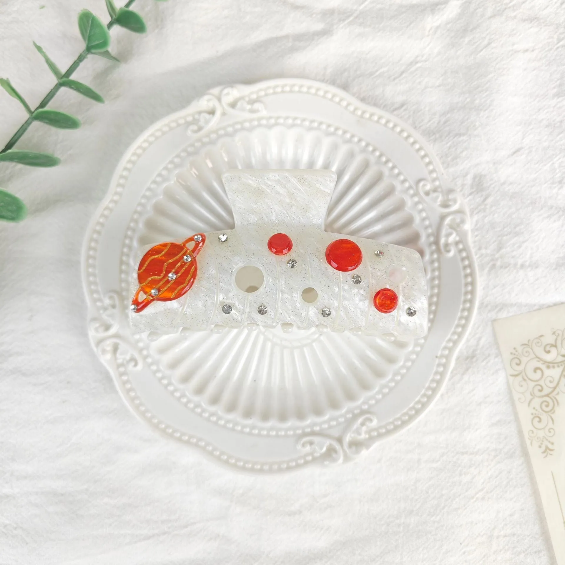 Oversized women's barrette with star moon starry sky design in cellulose acetate sheet material