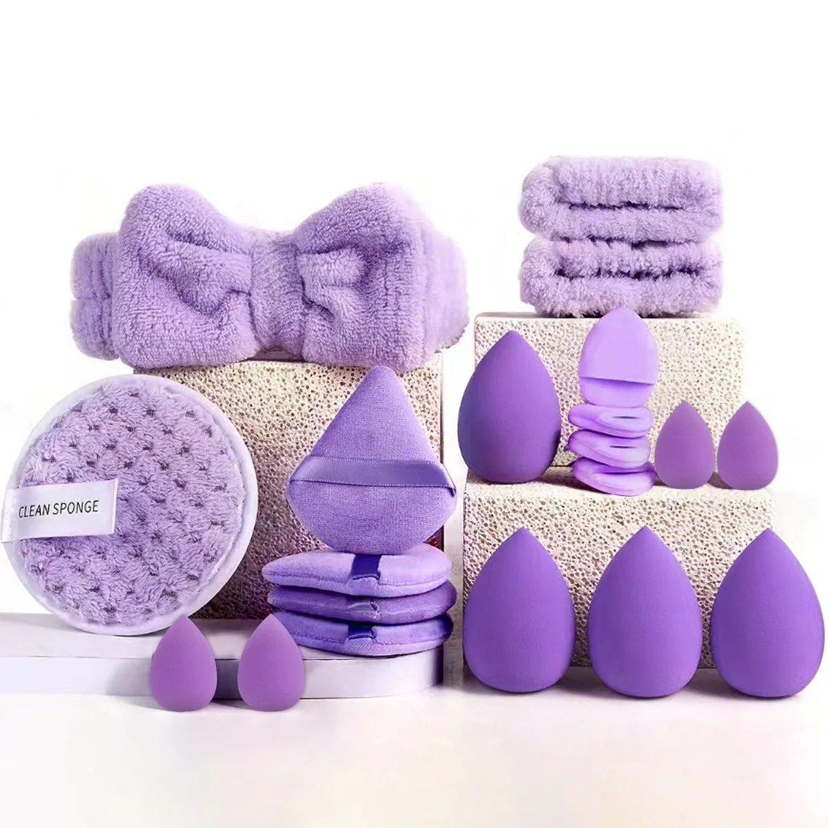 Beauty tool combination set with multiple pieces in brown, pink, and purple colours for face wash and makeup application