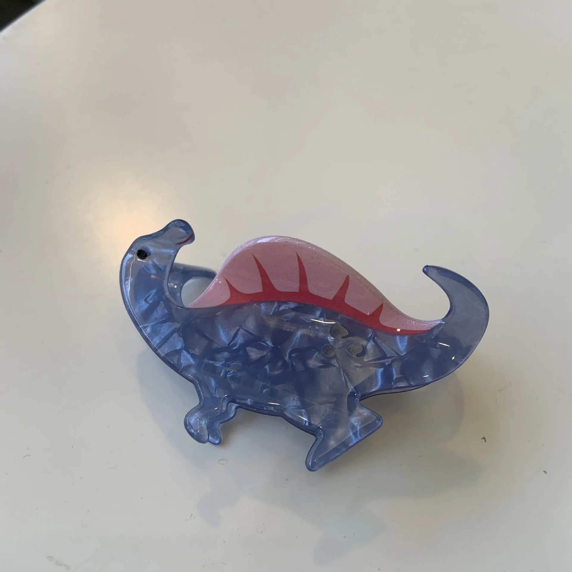 Colourful dinosaur acrylic jaw clip hairpin showing grip design with dinosaur motif