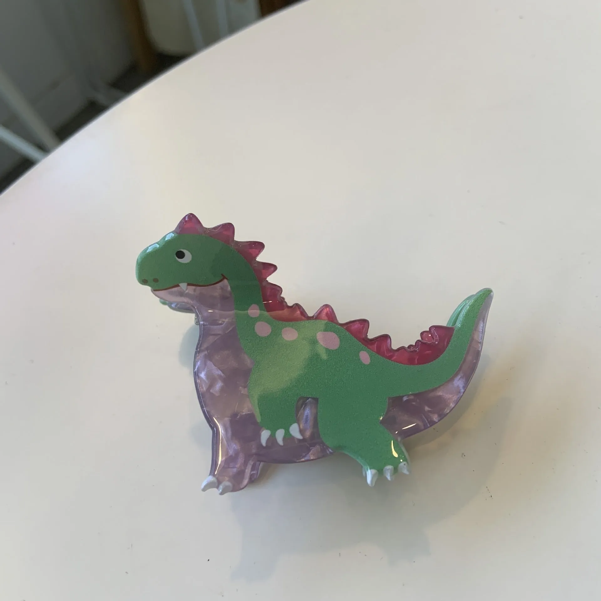 Colourful dinosaur acrylic jaw clip hairpin showing grip design with dinosaur motif