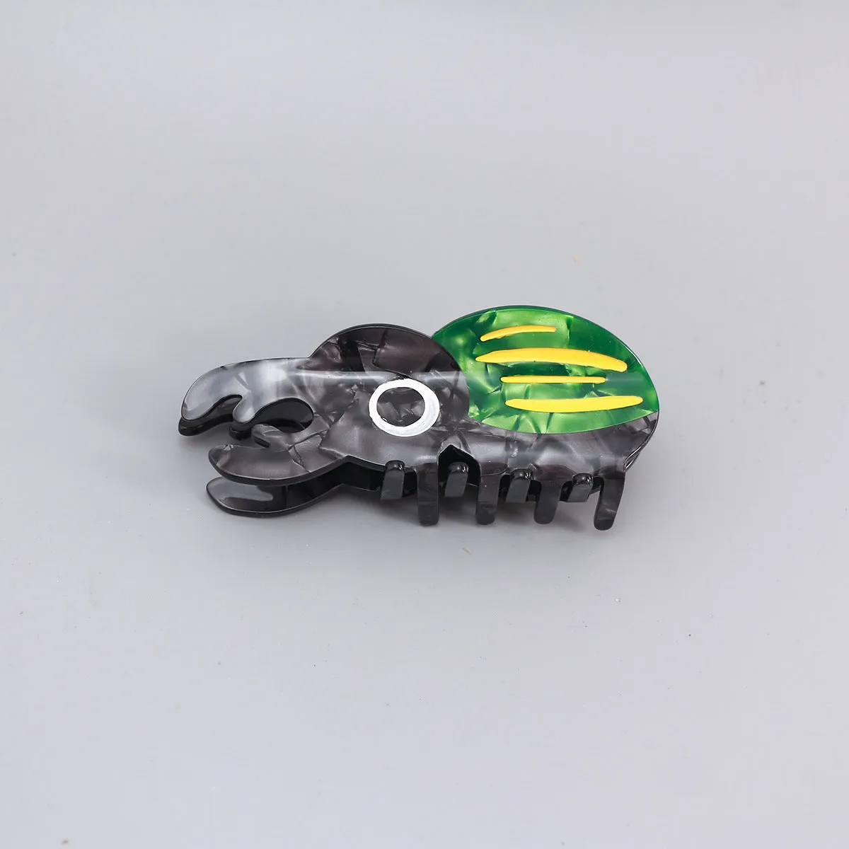 Handmade cellulose acetate beetle grip accessory with cartoon insect biology design in green or orange colour