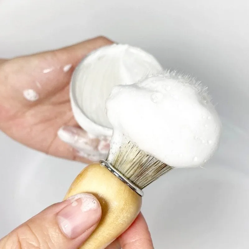 Mint scented shaving soap in aluminium box with rich foam on brush