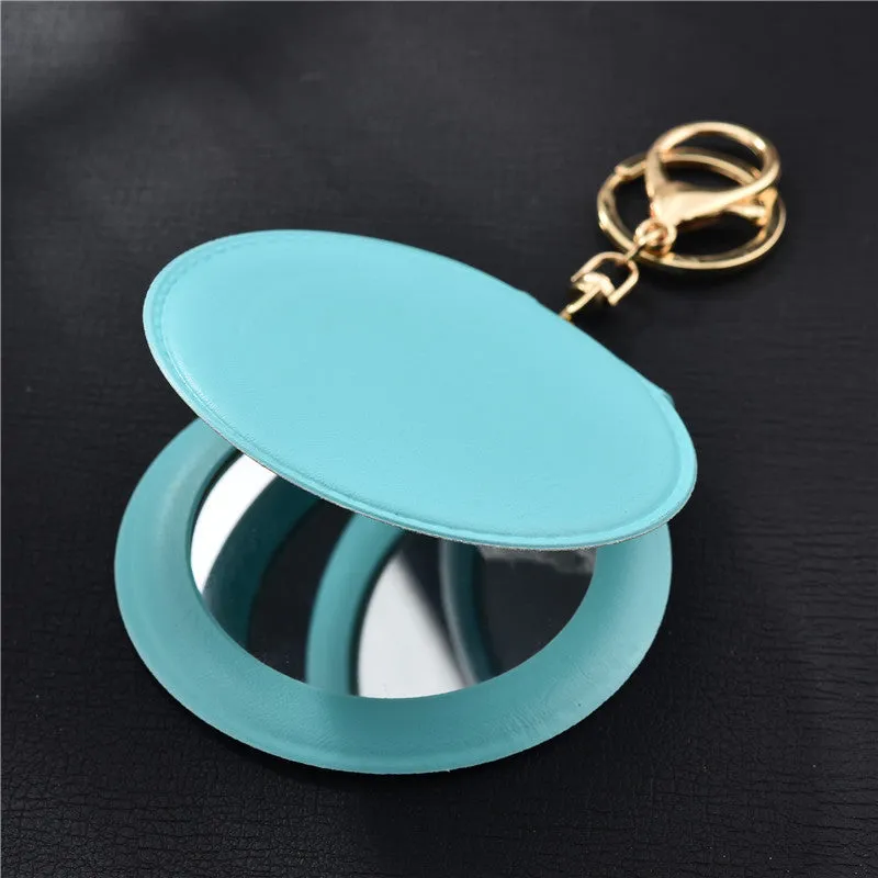 Compact round ladies leather makeup mirror with 8cm diameter glass surface and golden buckle
