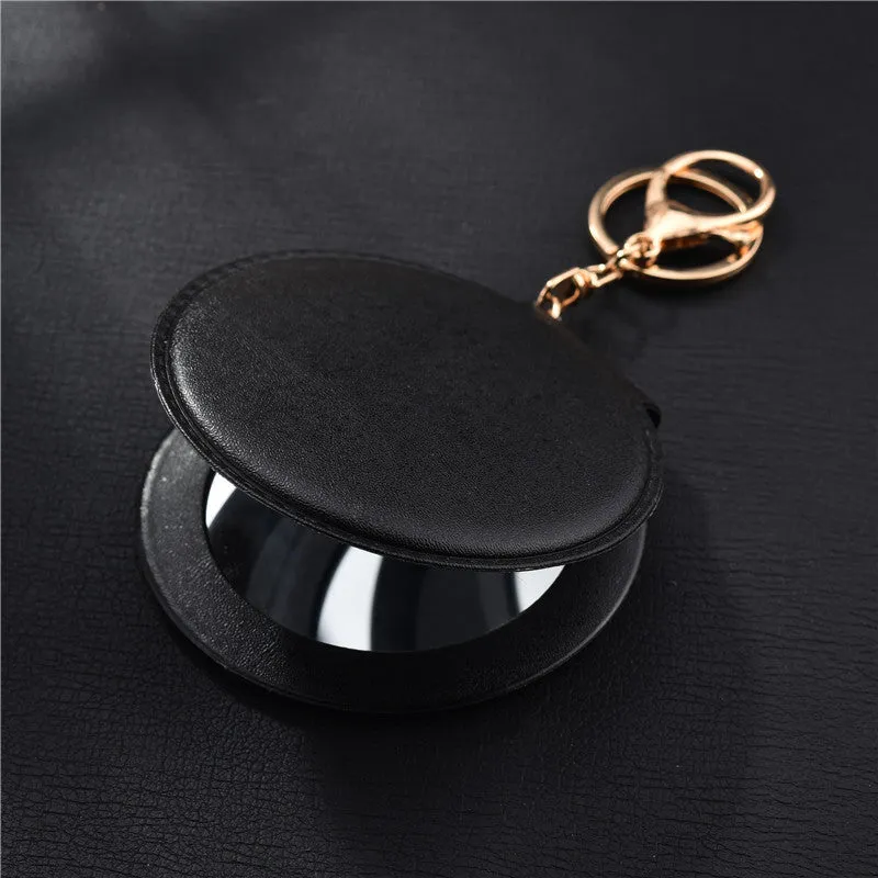 Compact round ladies leather makeup mirror with 8cm diameter glass surface and golden buckle