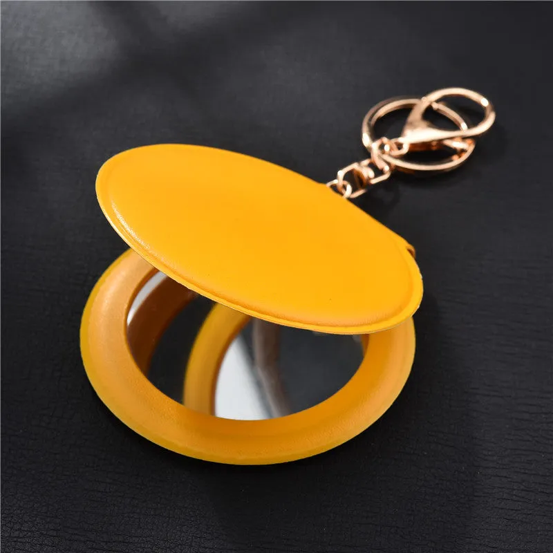 Compact round ladies leather makeup mirror with 8cm diameter glass surface and golden buckle