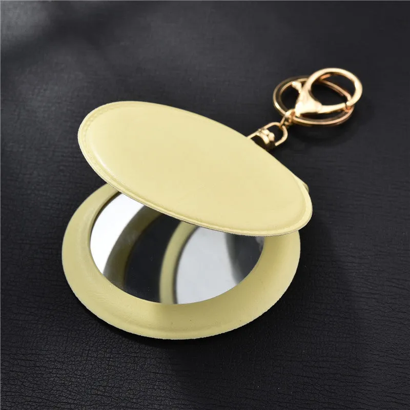 Compact round ladies leather makeup mirror with 8cm diameter glass surface and golden buckle