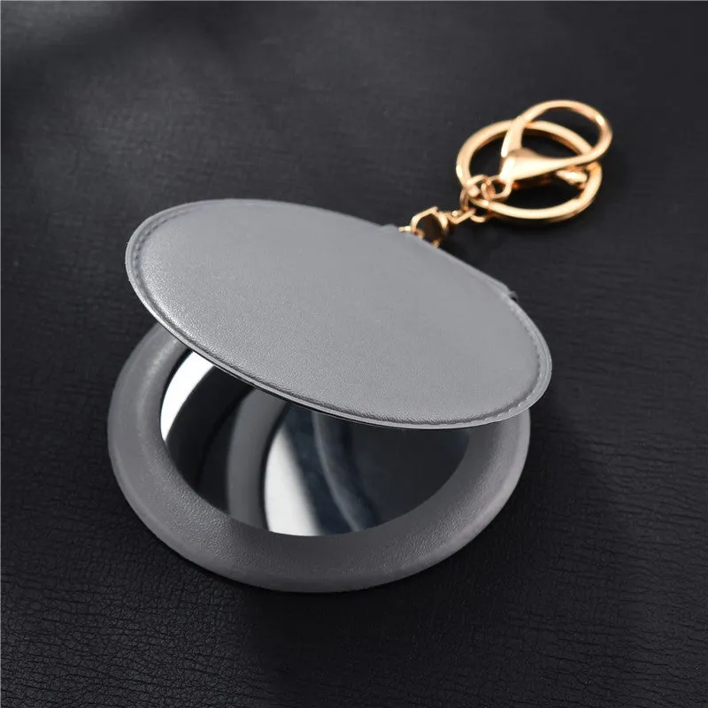 Compact round ladies leather makeup mirror with 8cm diameter glass surface and golden buckle