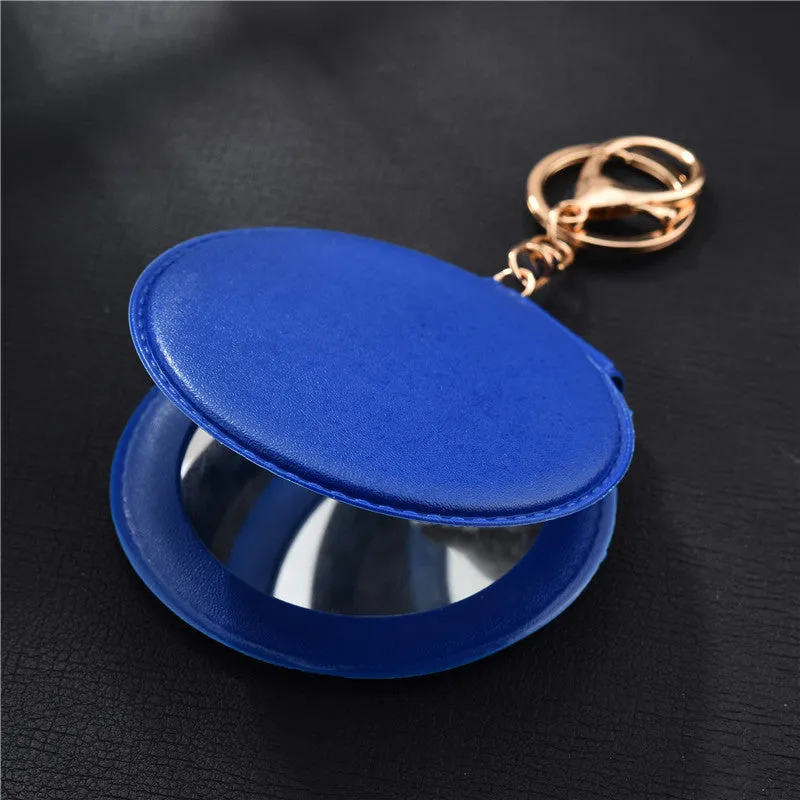Compact round ladies leather makeup mirror with 8cm diameter glass surface and golden buckle