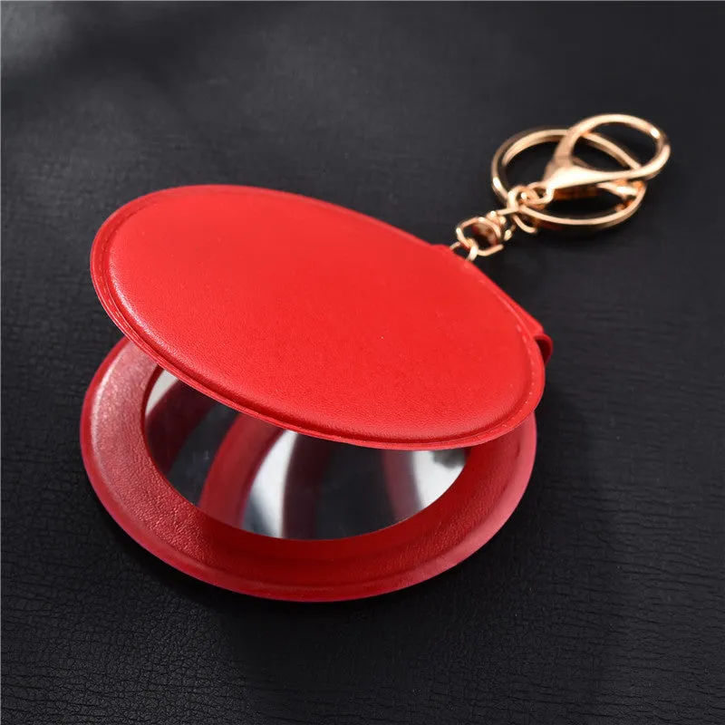 Compact round ladies leather makeup mirror with 8cm diameter glass surface and golden buckle
