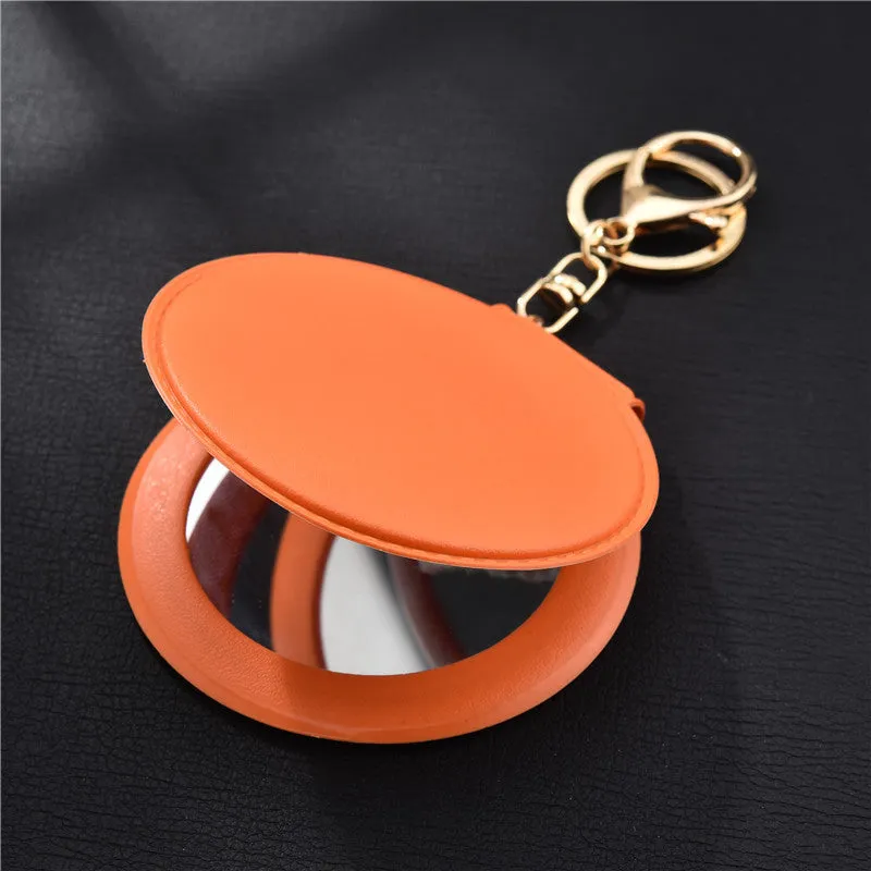 Compact round ladies leather makeup mirror with 8cm diameter glass surface and golden buckle