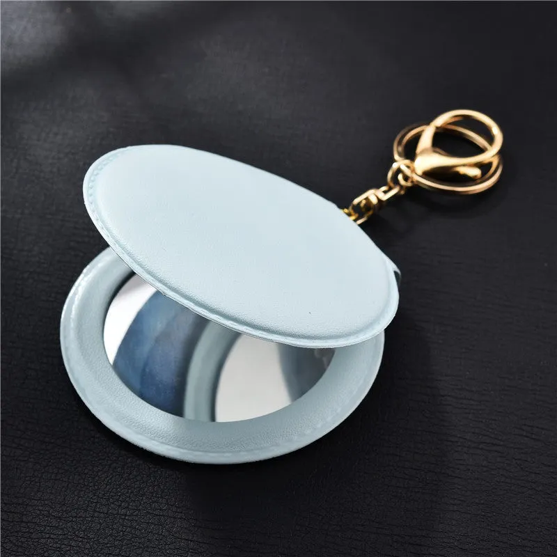 Compact round ladies leather makeup mirror with 8cm diameter glass surface and golden buckle