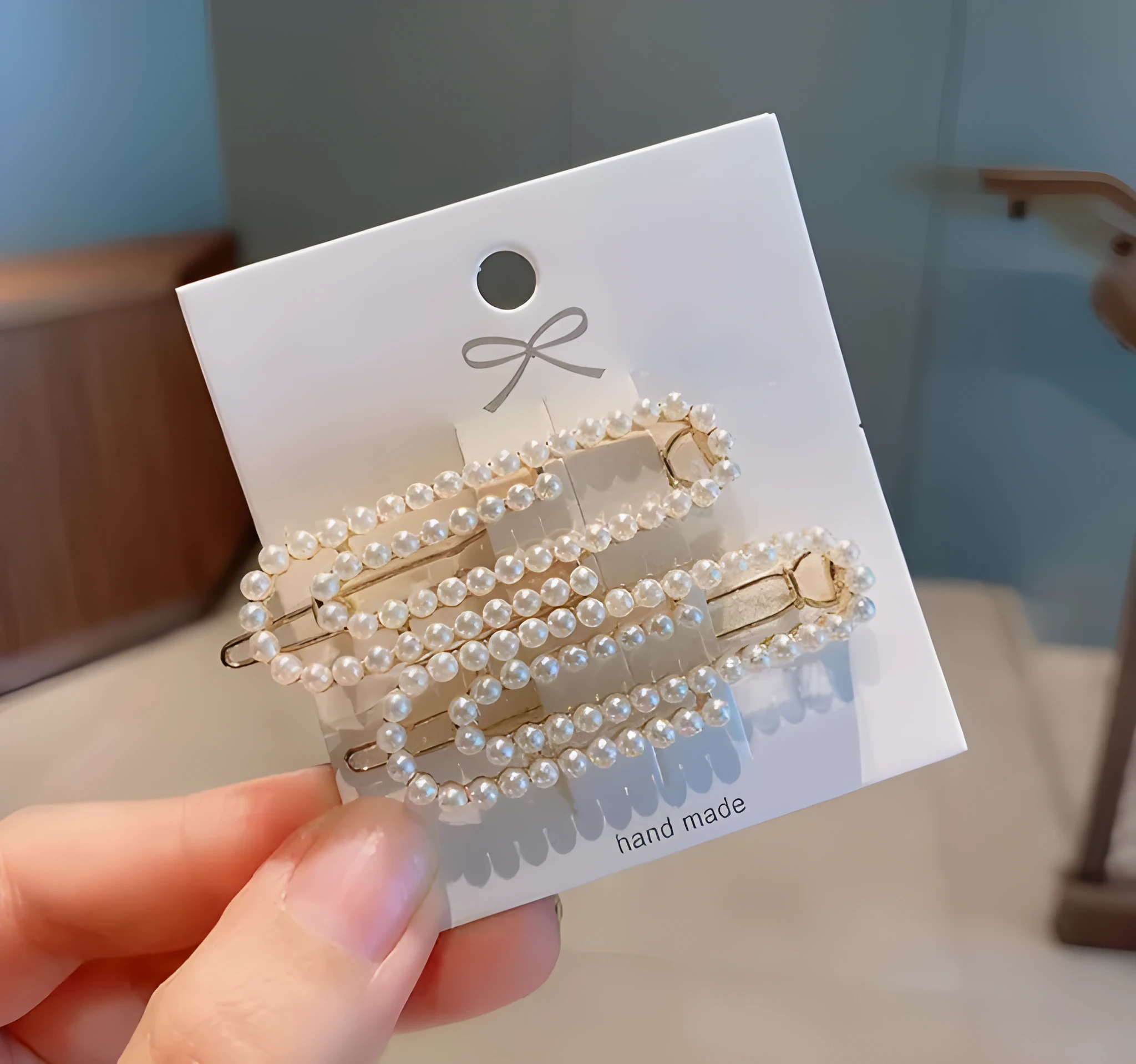 White pearl hair clip set with geometric weaving pattern on metal acrylic base