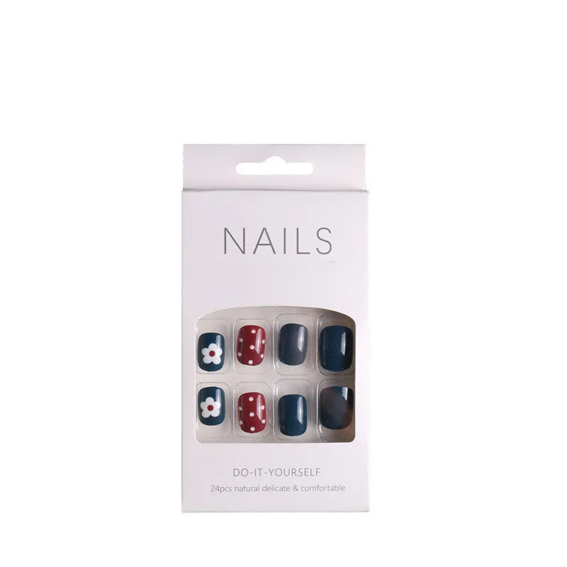 Fake nail patch with matte black and white lines design on a white background