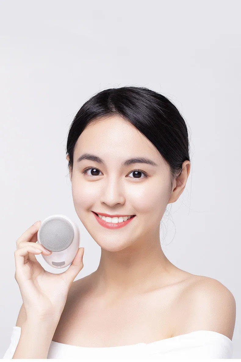 White multifunction USB charging facial cleansing massager with hot egg design, silicone brush head, and 5 vibration modes on a white background