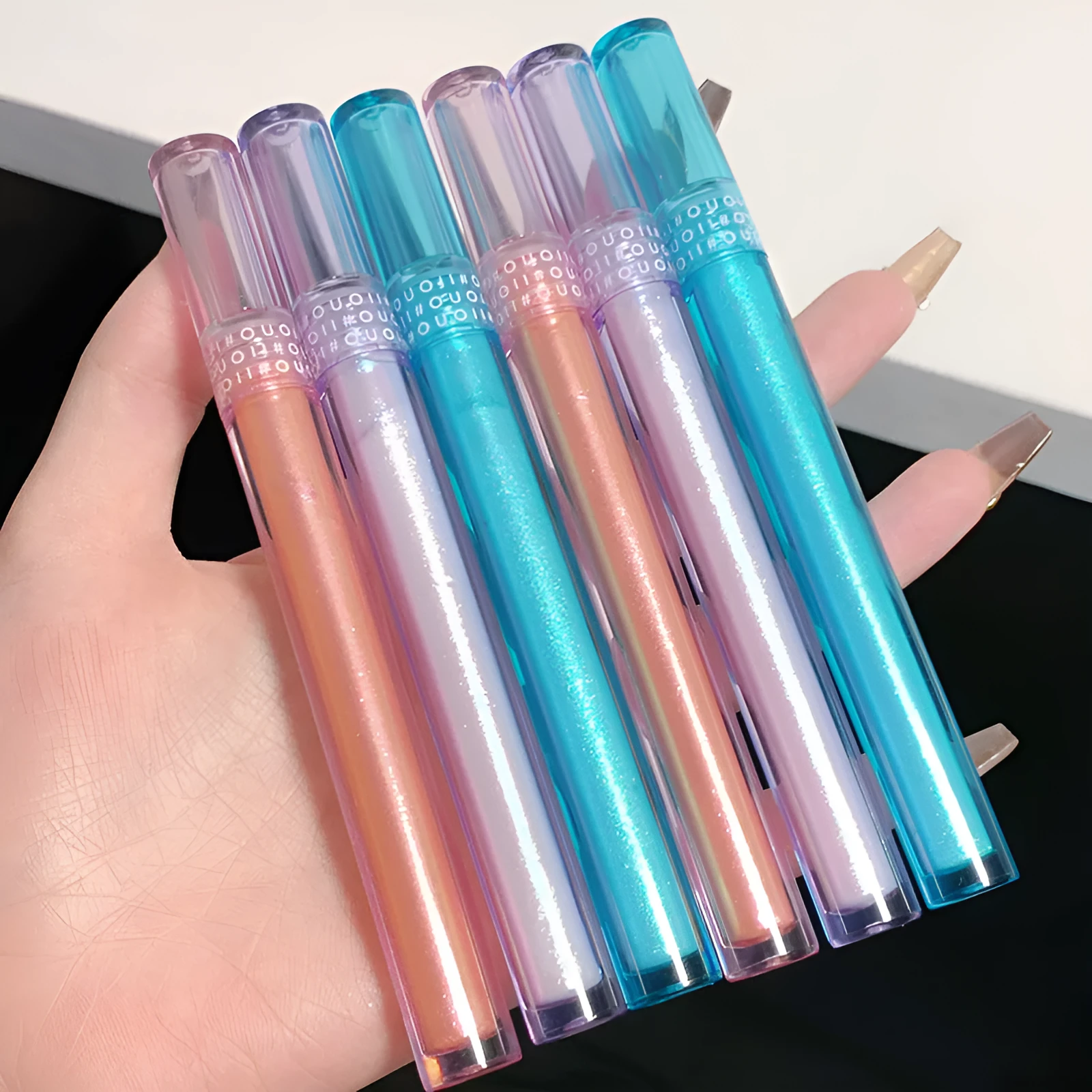 Lying Silkworm liquid eye shadow cosmetics in Coral Sea shade, slim 13.6cm bottle with glitter pigment
