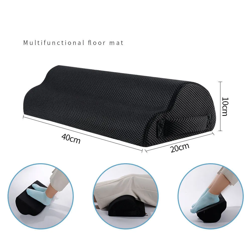 Semi-circular black foot rest pillow 40x20x10cm on floor under desk