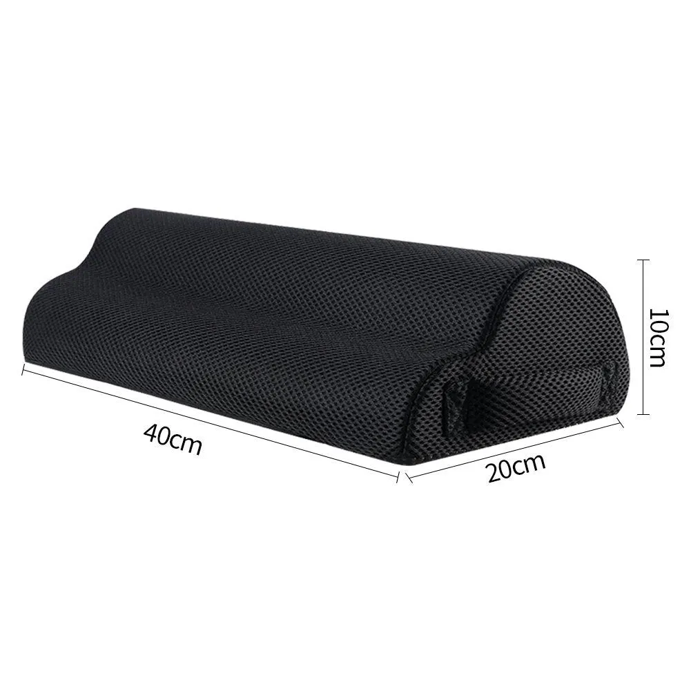 Semi-circular black foot rest pillow 40x20x10cm on floor under desk
