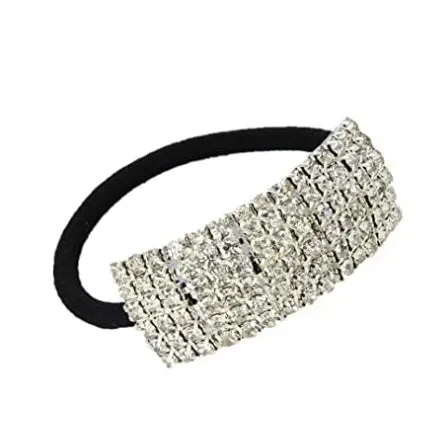 Three silver hair rings with rhinestone crystals on a light background