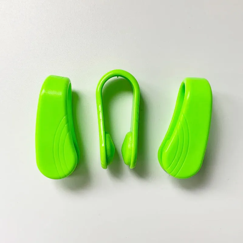 Tiger mouth massage clip multi-function acupoint massager in black on a hand, showing placement between thumb and index finger