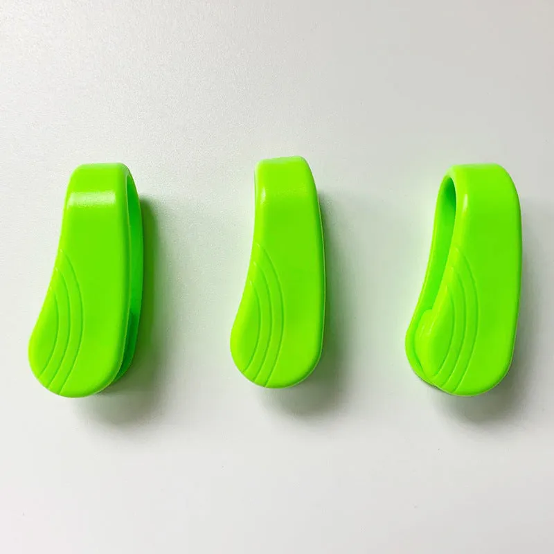 Tiger mouth massage clip multi-function acupoint massager in black on a hand, showing placement between thumb and index finger