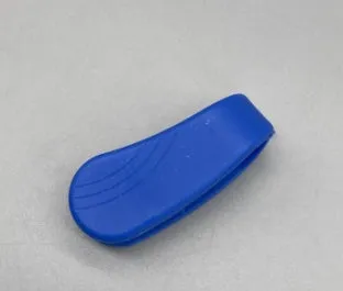 Tiger mouth massage clip multi-function acupoint massager in black on a hand, showing placement between thumb and index finger