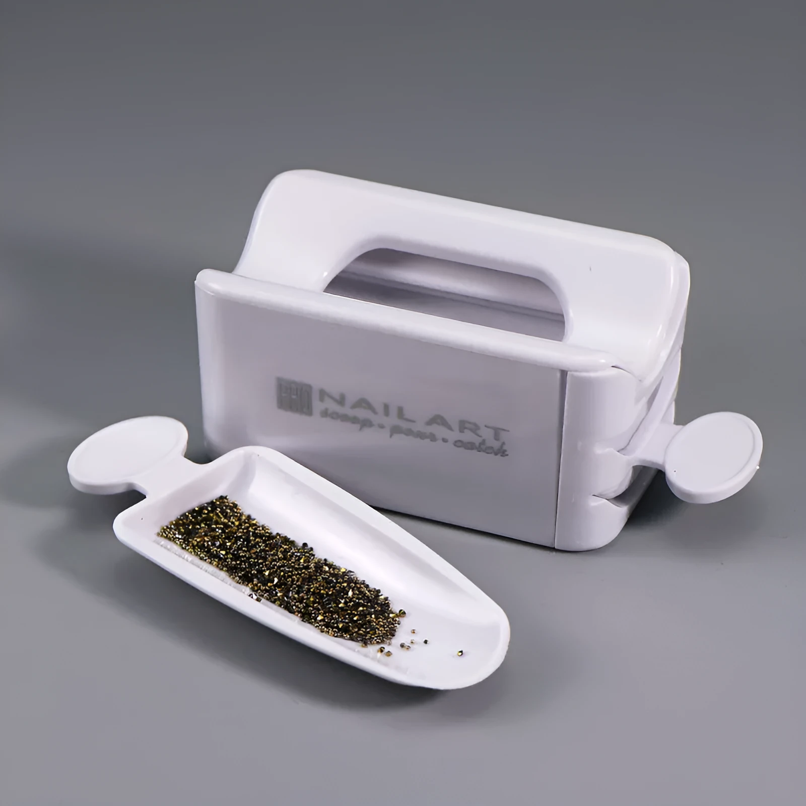 Three-layer white plastic nail powder box on a table for storing nail powder containers