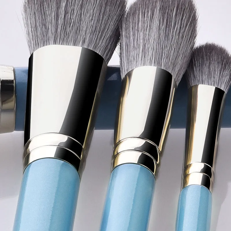 Blue 13-piece synthetic hair makeup brush set with wooden handles and aluminum ferrules on a clean surface