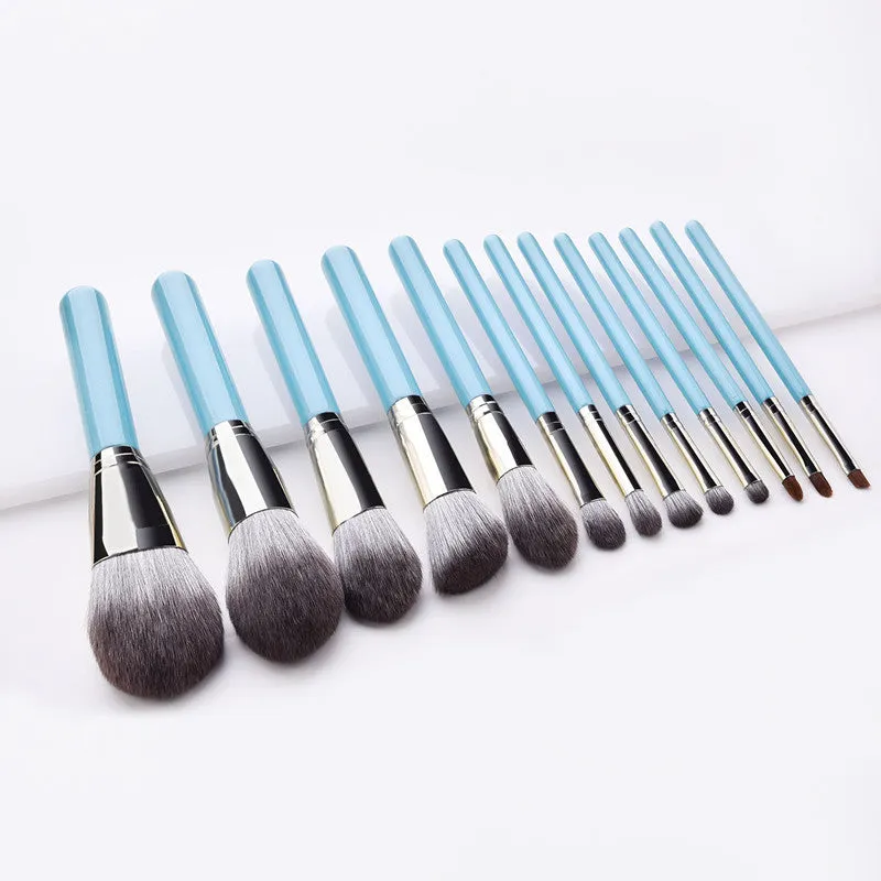 Blue 13-piece synthetic hair makeup brush set with wooden handles and aluminum ferrules on a clean surface
