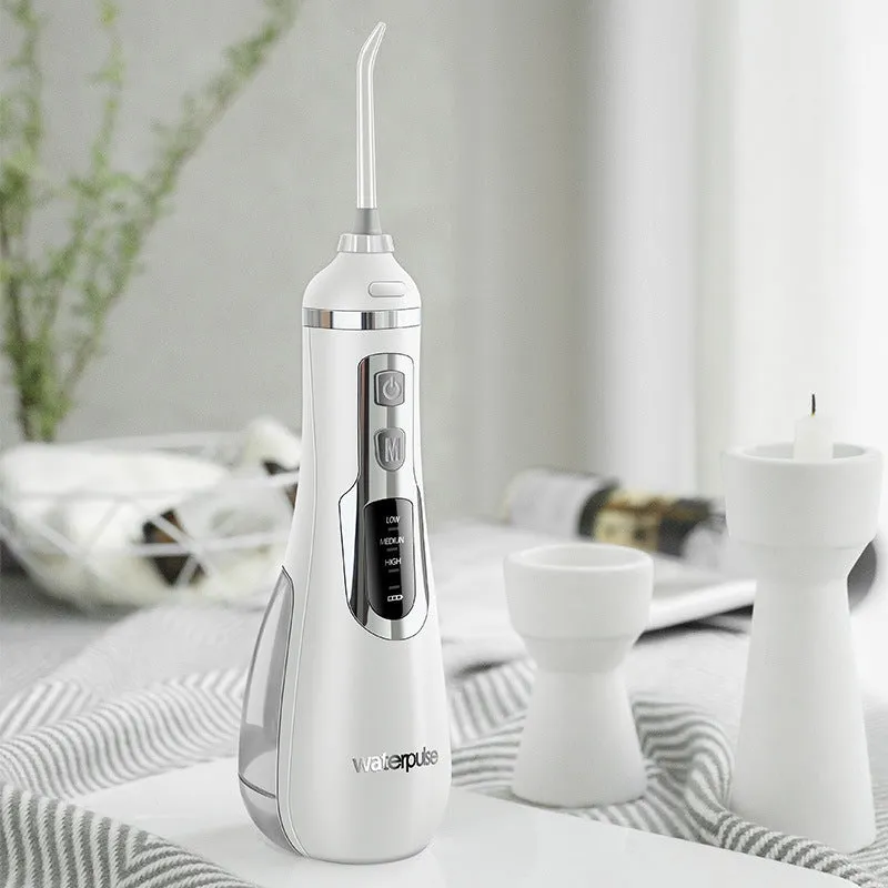 V500 portable electric dental flusher in white with black carrying case on bathroom counter