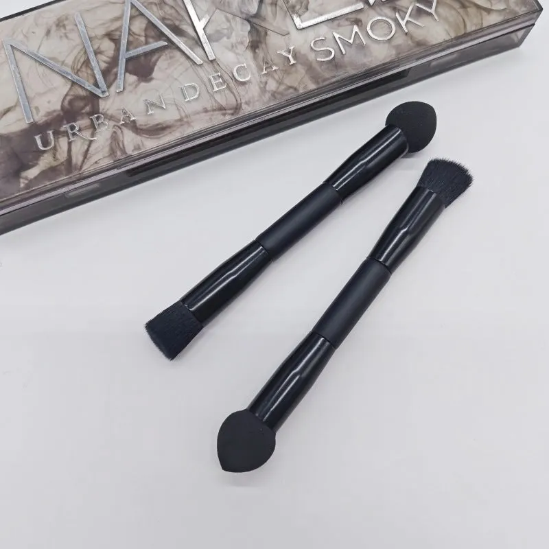 Double-headed concealer brush with black wooden handle, artificial fibre bristles, and angled sponge tip.