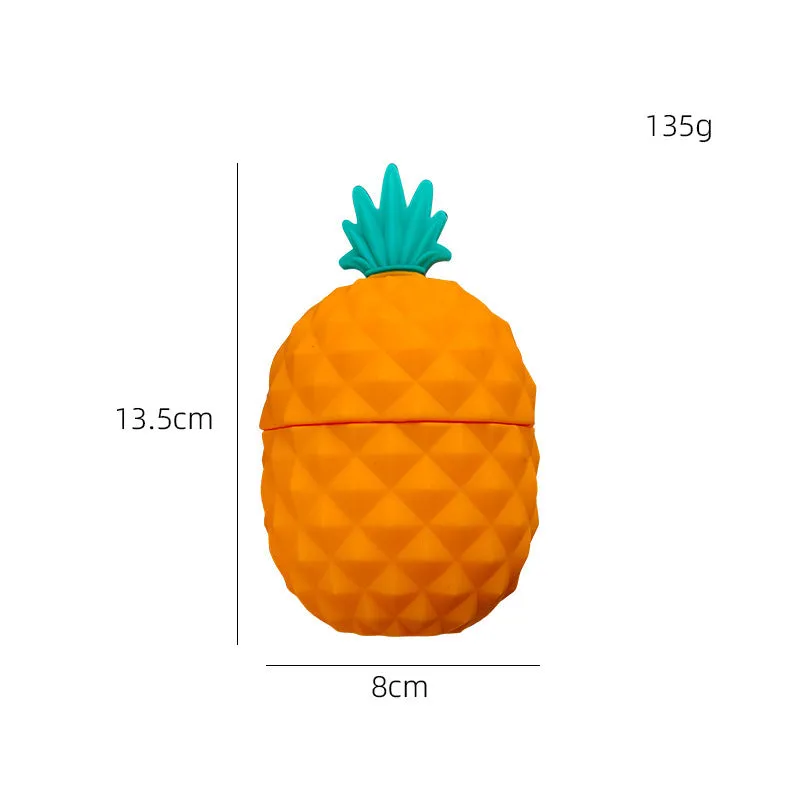 Silicone facial ice mold in pineapple style, pink colour, with ice cubes on a white background