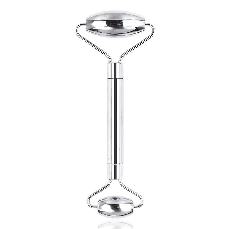 Stainless steel double-headed facial roller, heart-shaped acupressure stick, and scraping plate on a white background.