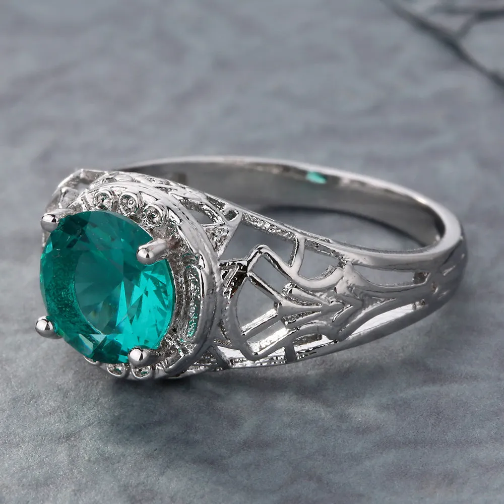 Copper electroplated silver ring with a clear zircon stone inlay on a neutral background