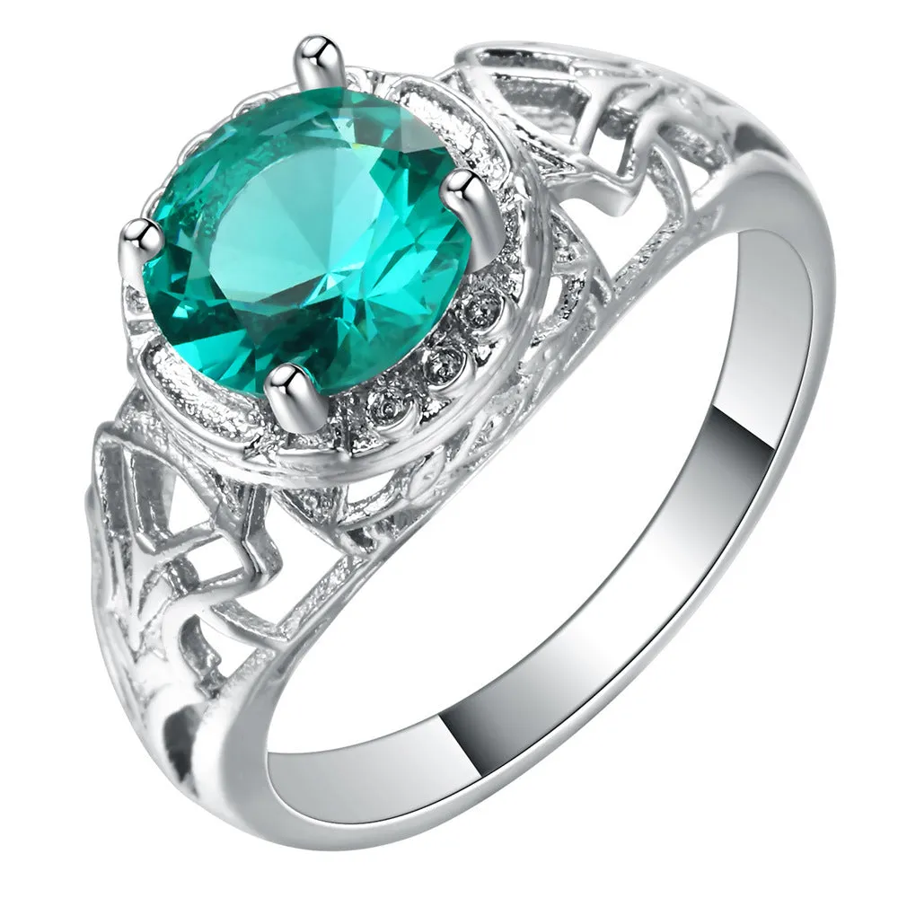 Copper electroplated silver ring with a clear zircon stone inlay on a neutral background