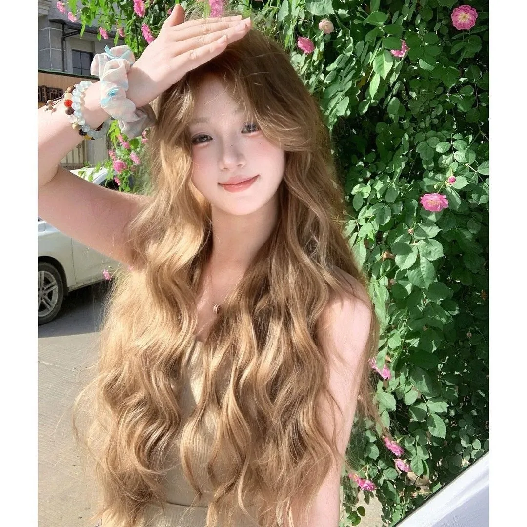 Medium size long curly wig in linen colour made from high temperature synthetic fibre.