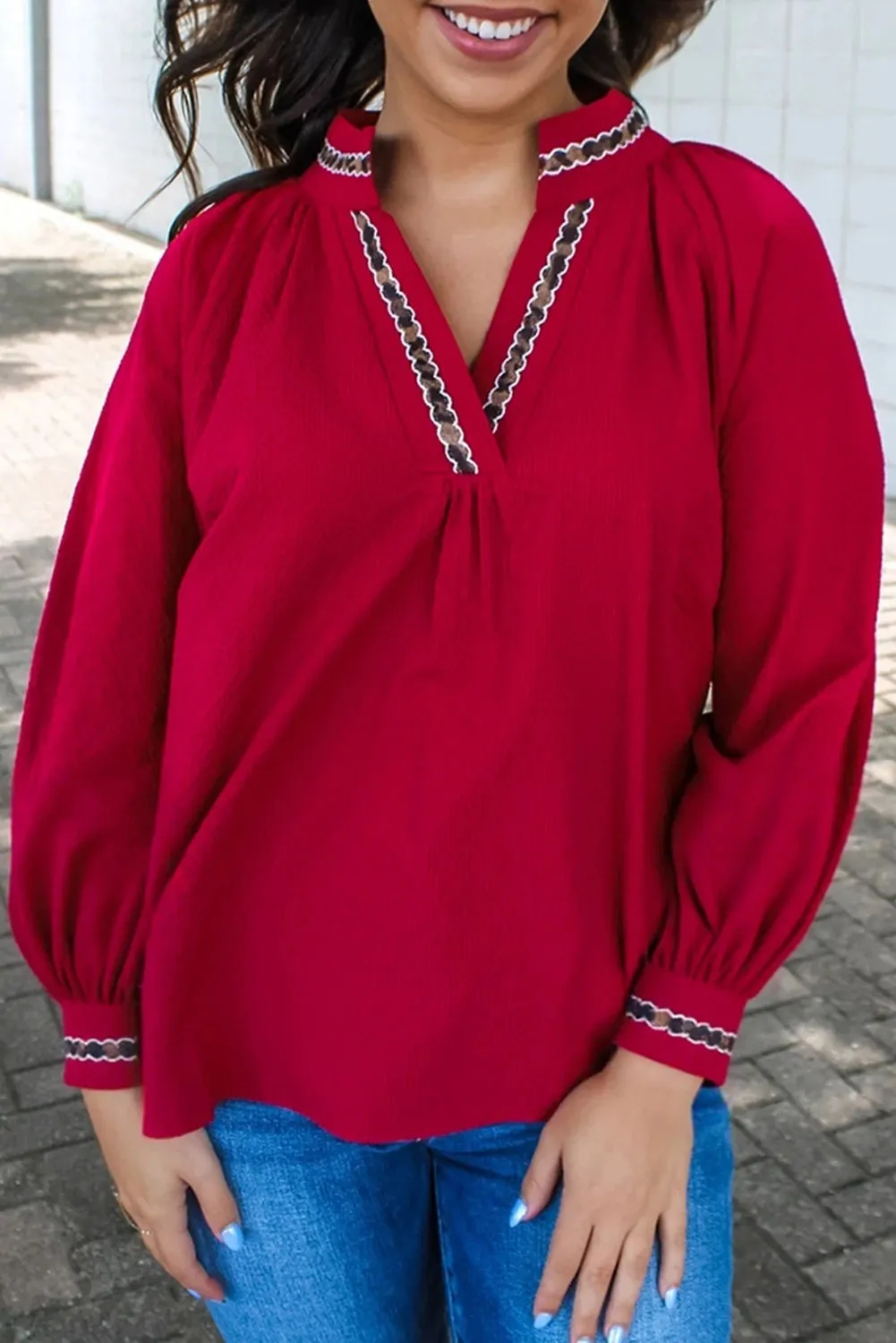 Women's red polyester pullover shirt with embroidered collar and printed design, loose fit
