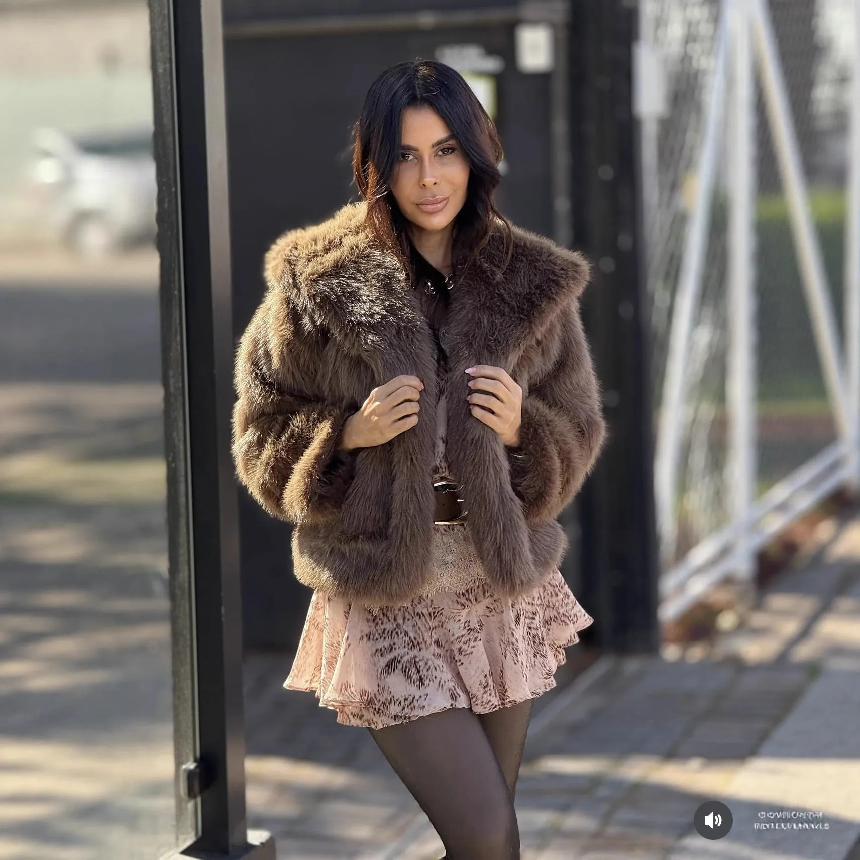 Women's brown loose hooded jacket with fox fur trim on a white background, front view