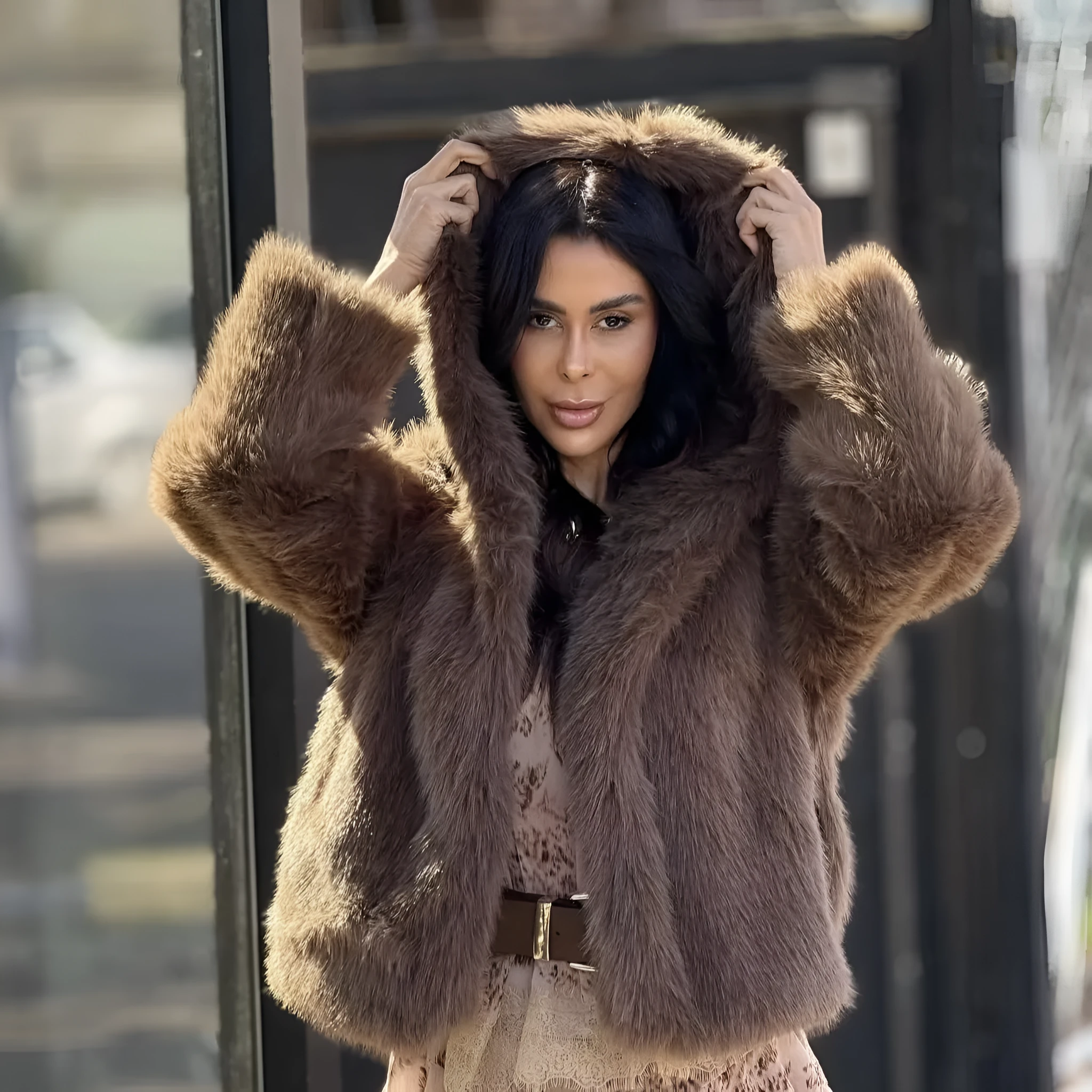 Women's brown loose hooded jacket with fox fur trim on a white background, front view