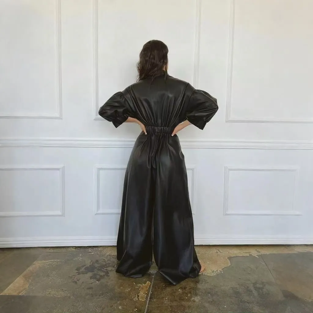 Black PU retro loose jumpsuit with puff sleeves, high waist, button front, and splicing details